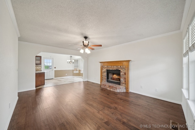 9227 S 95th E Ave, Tulsa, OK 74133 - unfurnished living room with a chandelier, a ceiling fan, a brick fireplace, a textured ceiling, and dark wood-style flooring