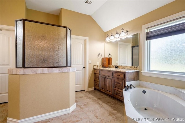 15065 N 148th Ave E, Collinsville, OK 74021 - bathroom featuring a stall shower, a jetted tub, vanity, and vaulted ceiling