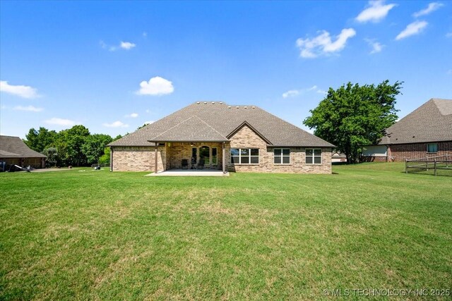 15065 N 148th Ave E, Collinsville, OK 74021 - rear view of property featuring a patio area, a yard, and brick siding