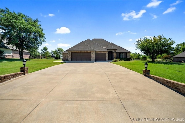 15065 N 148th Ave E, Collinsville, OK 74021 - view of front of home featuring a garage, concrete driveway, and a front lawn