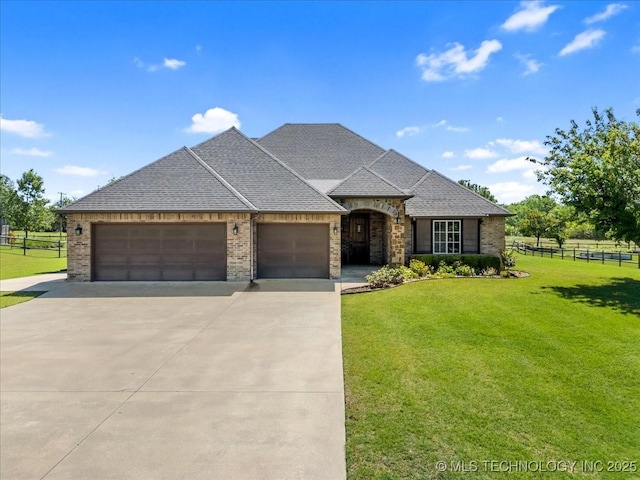 15065 N 148th Ave E, Collinsville, OK 74021 - french provincial home with an attached garage, concrete driveway, brick siding, and roof with shingles