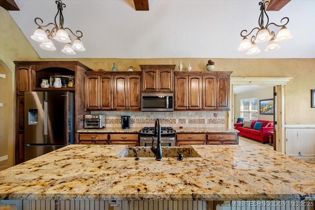 15065 N 148th Ave E, Collinsville, OK 74021 - kitchen featuring appliances with stainless steel finishes, a chandelier, a large island, light stone counters, and vaulted ceiling