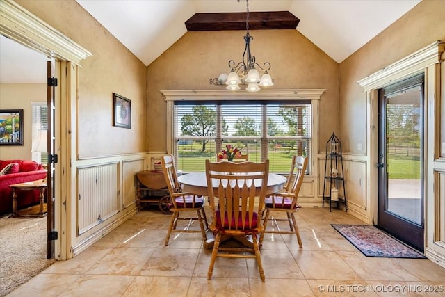 15065 N 148th Ave E, Collinsville, OK 74021 - dining space featuring lofted ceiling, a chandelier, a decorative wall, and wainscoting