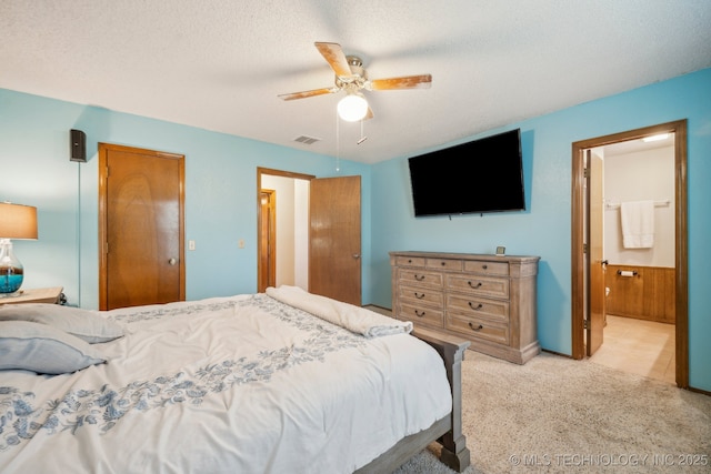 2630 W Boston Pl, Broken Arrow, OK 74012 - bedroom with light carpet, ceiling fan, ensuite bathroom, and a textured ceiling