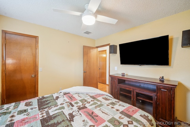 2630 W Boston Pl, Broken Arrow, OK 74012 - bedroom featuring a textured ceiling and ceiling fan