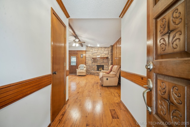 2630 W Boston Pl, Broken Arrow, OK 74012 - hall featuring light wood finished floors, wood walls, and a textured ceiling