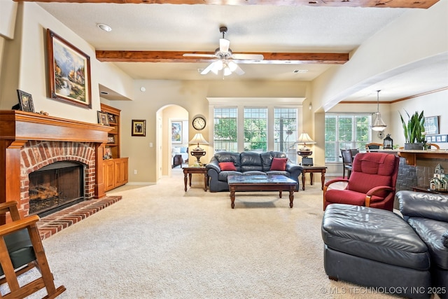 11715 S 93rd E Ave, Bixby, OK 74008 - living area with arched walkways, beamed ceiling, carpet flooring, a fireplace, and a ceiling fan