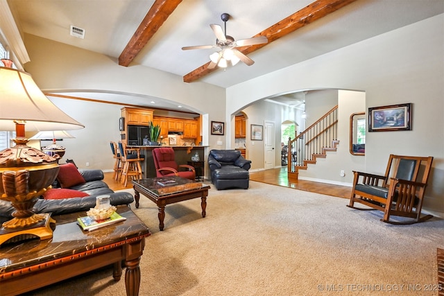 11715 S 93rd E Ave, Bixby, OK 74008 - carpeted living area featuring arched walkways, a ceiling fan, beamed ceiling, and stairway