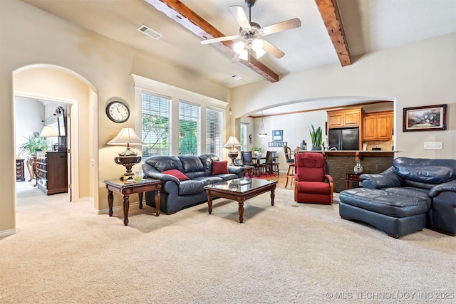 11715 S 93rd E Ave, Bixby, OK 74008 - living room with light colored carpet, arched walkways, beamed ceiling, and ceiling fan