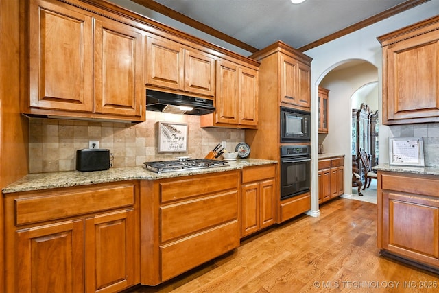 11715 S 93rd E Ave, Bixby, OK 74008 - kitchen with black appliances, under cabinet range hood, light wood-style flooring, brown cabinetry, and ornamental molding