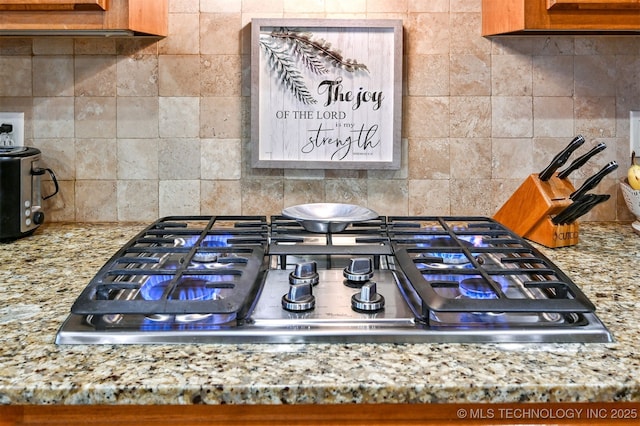 11715 S 93rd E Ave, Bixby, OK 74008 - kitchen view of stainless steel gas cooktop, tasteful backsplash, and light stone counters