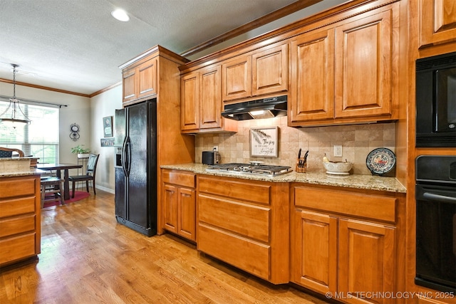11715 S 93rd E Ave, Bixby, OK 74008 - kitchen with black appliances, under cabinet range hood, ornamental molding, brown cabinets, and tasteful backsplash