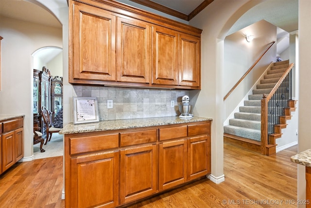 11715 S 93rd E Ave, Bixby, OK 74008 - kitchen featuring arched walkways, light wood-style flooring, and brown cabinets