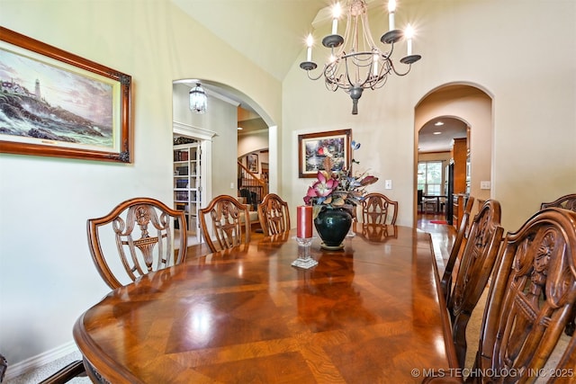 11715 S 93rd E Ave, Bixby, OK 74008 - dining room with arched walkways, a chandelier, and a high ceiling