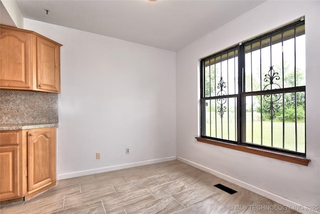 134 Spunky Creek Dr, Catoosa, OK 74015 - unfurnished dining area featuring baseboards