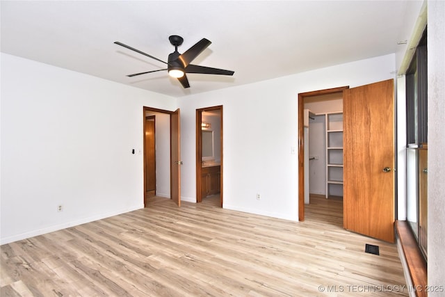 134 Spunky Creek Dr, Catoosa, OK 74015 - unfurnished bedroom featuring light wood-type flooring, connected bathroom, a spacious closet, a closet, and baseboards