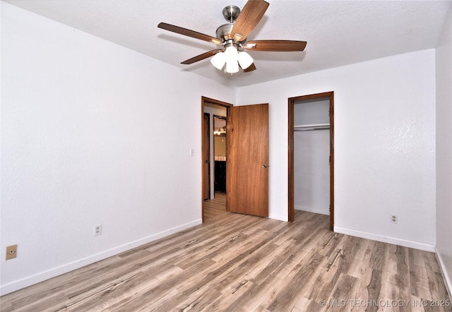 134 Spunky Creek Dr, Catoosa, OK 74015 - unfurnished bedroom with wood finished floors, baseboards, a closet, and a ceiling fan