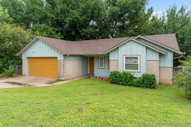 349 S 185th E Ave, Tulsa, OK 74108 - ranch-style home with a shingled roof, a garage, brick siding, concrete driveway, and board and batten siding