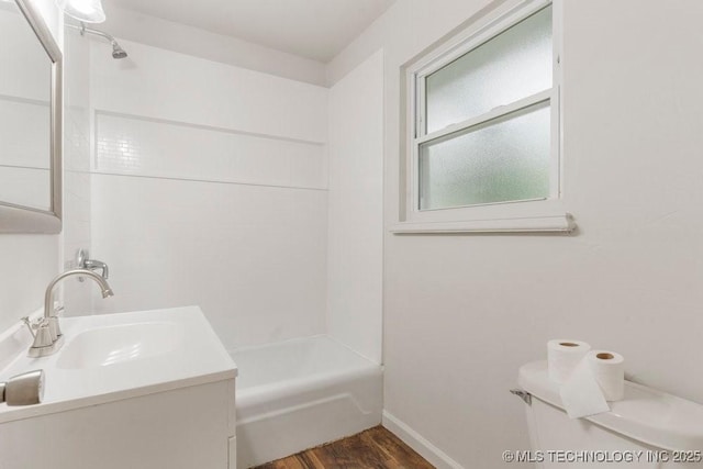 349 S 185th E Ave, Tulsa, OK 74108 - bathroom with wood finished floors, vanity, baseboards, shower / tub combination, and toilet