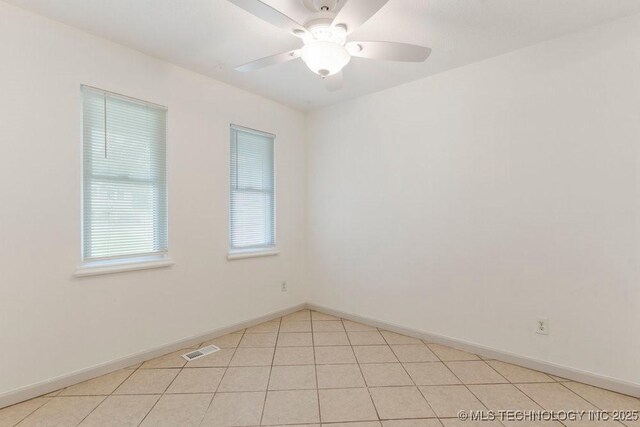 349 S 185th E Ave, Tulsa, OK 74108 - spare room featuring ceiling fan, baseboards, and light tile patterned floors