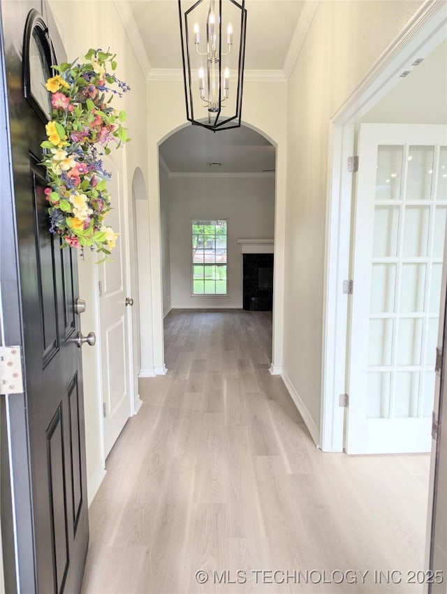 7870 N 163rd E Ct, Owasso, OK 74055 - foyer entrance with arched walkways, crown molding, light wood-style floors, baseboards, and a chandelier