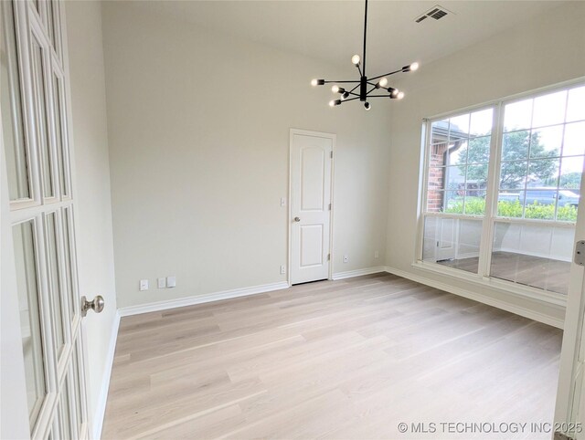 7870 N 163rd E Ct, Owasso, OK 74055 - empty room featuring a chandelier, light wood finished floors, and baseboards