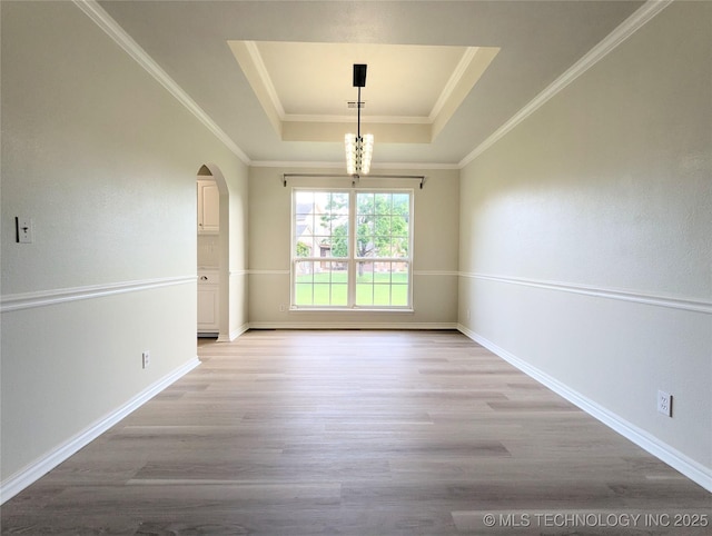 7870 N 163rd E Ct, Owasso, OK 74055 - unfurnished dining area featuring a tray ceiling, arched walkways, light wood-style flooring, baseboards, and crown molding