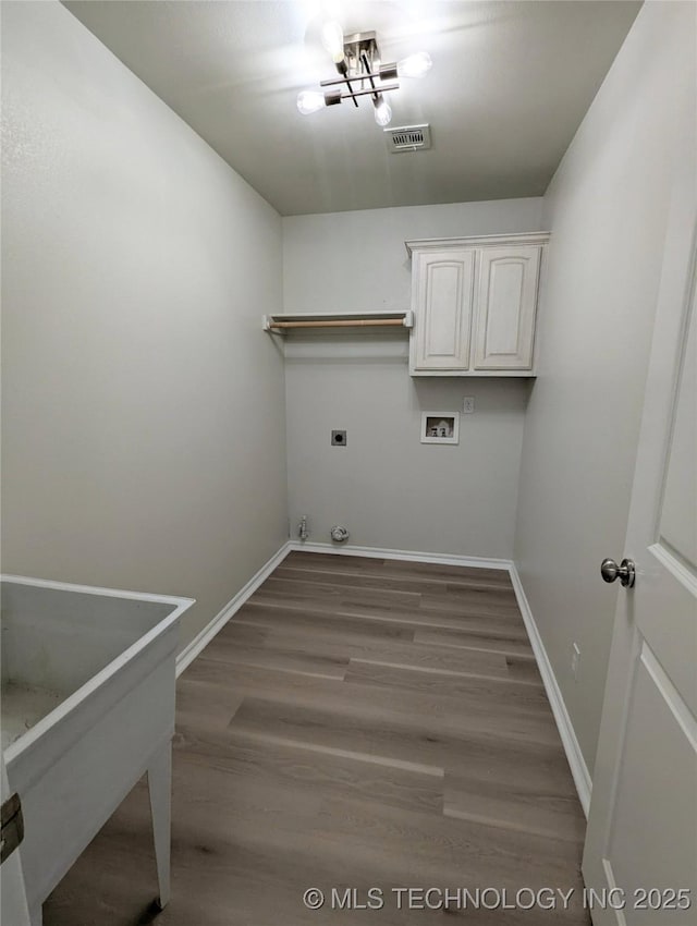7870 N 163rd E Ct, Owasso, OK 74055 - laundry area featuring cabinet space, washer hookup, baseboards, wood finished floors, and electric dryer hookup