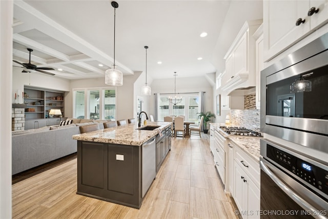 602 E 130th St S, Jenks, OK 74037 - kitchen featuring stainless steel appliances, white cabinetry, plenty of natural light, recessed lighting, and beamed ceiling