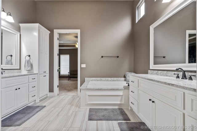 12934 S 2nd St, Jenks, OK 74037 - bathroom with healthy amount of natural light, two vanities, a garden tub, and ceiling fan