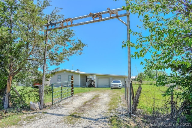 919 N 4210th Rd, Hugo, OK 74743 - view of front of house featuring driveway, a garage, and a gate