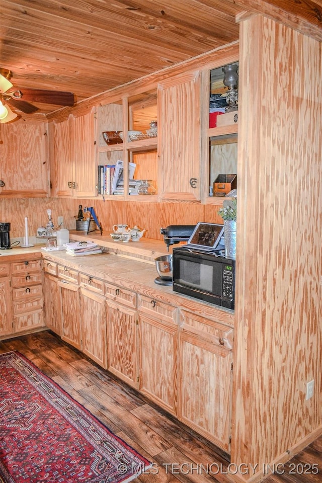 919 N 4210th Rd, Hugo, OK 74743 - kitchen with wooden ceiling, dark wood-type flooring, light brown cabinets, light countertops, and black microwave