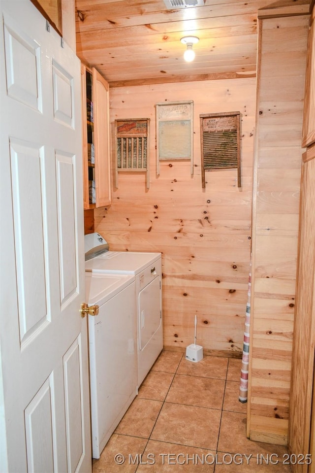 919 N 4210th Rd, Hugo, OK 74743 - laundry area featuring washing machine and clothes dryer, wooden ceiling, wood walls, and light tile patterned flooring