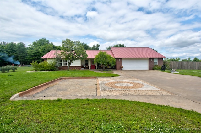 2430 S 31st St E, Muskogee, OK 74403 - ranch-style home featuring metal roof, driveway, brick siding, and a garage