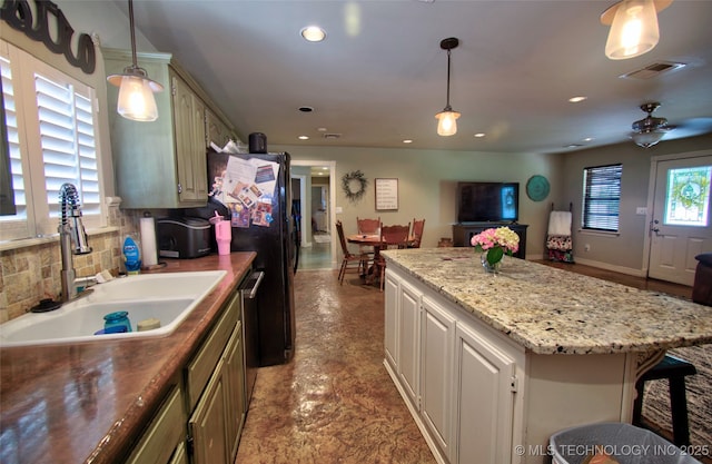 2430 S 31st St E, Muskogee, OK 74403 - kitchen featuring a sink, recessed lighting, a center island, light stone counters, and hanging light fixtures