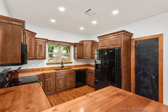 5687 Lake Jackson Rd, Mounds, OK 74047 - kitchen with black appliances, a sink, wood counters, light wood-type flooring, and recessed lighting