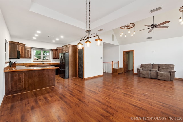 5687 Lake Jackson Rd, Mounds, OK 74047 - kitchen featuring freestanding refrigerator, open floor plan, dark wood-style flooring, a peninsula, and recessed lighting