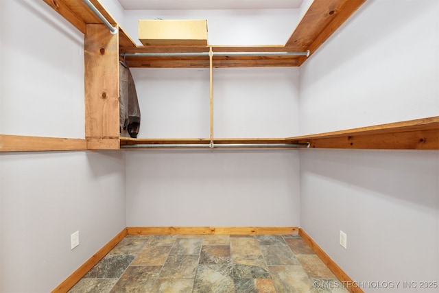 5687 Lake Jackson Rd, Mounds, OK 74047 - walk in closet with stone finish floors
