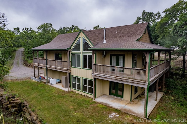 5687 Lake Jackson Rd, Mounds, OK 74047 - back of house featuring a patio area, a yard, french doors, a shingled roof, and a balcony