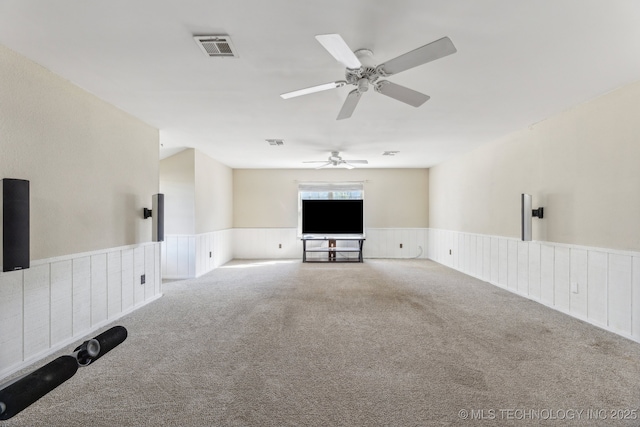 6506 E 99th St, Tulsa, OK 74133 - unfurnished living room with carpet flooring, a wainscoted wall, and a ceiling fan