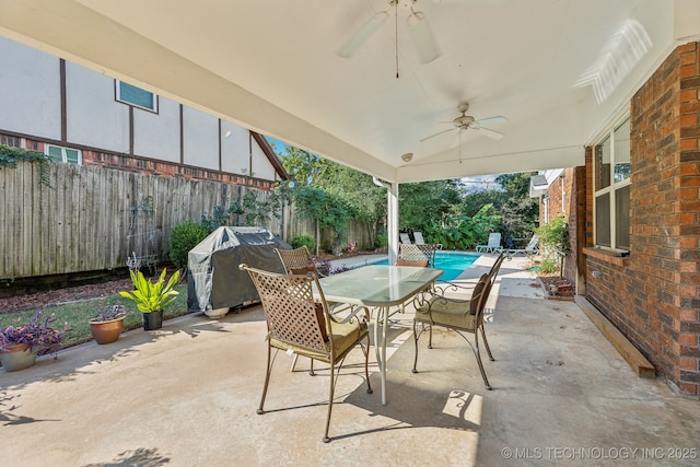 6506 E 99th St, Tulsa, OK 74133 - fenced backyard with a ceiling fan, area for grilling, a patio, and outdoor dining space