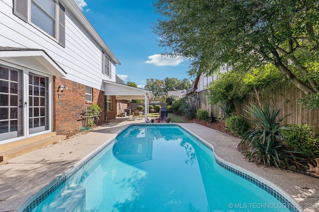 6506 E 99th St, Tulsa, OK 74133 - view of pool featuring a patio area, a fenced backyard, and french doors