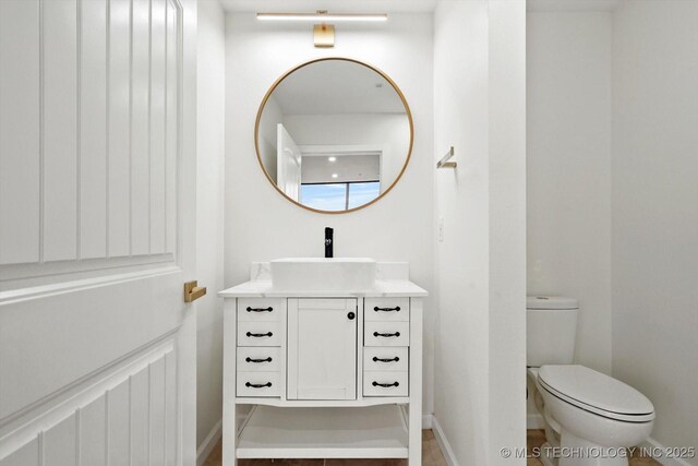 5810 E Skelly Dr Unit 303, Tulsa, OK 74135 - bathroom with vanity, toilet, and baseboards