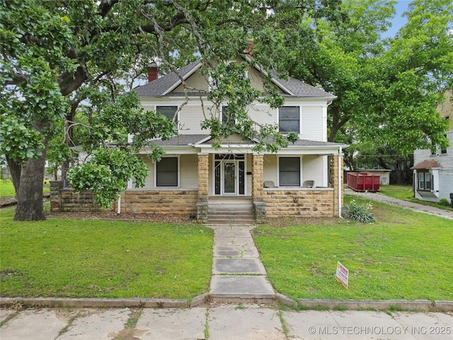 410 S Seminole Ave, Okmulgee, OK 74447 - view of front facade featuring stone siding, covered porch, a front lawn, and a shingled roof