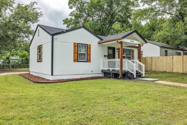 6948 E Marshall Pl, Tulsa, OK 74115 - view of front facade featuring a shingled roof and a porch
