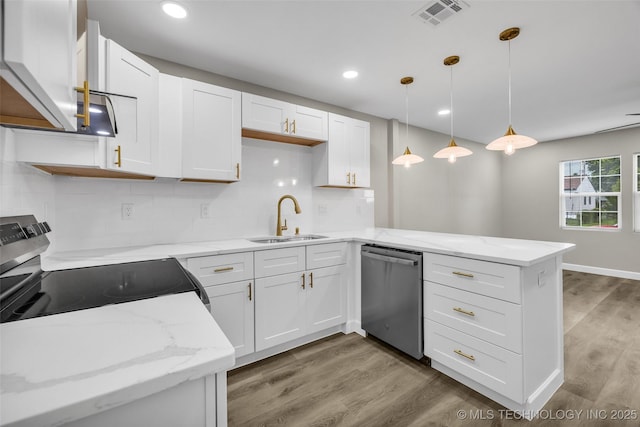 6948 E Marshall Pl, Tulsa, OK 74115 - kitchen featuring appliances with stainless steel finishes, a sink, a peninsula, white cabinets, and recessed lighting