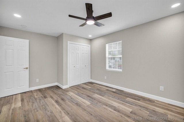 6948 E Marshall Pl, Tulsa, OK 74115 - unfurnished bedroom featuring wood finished floors, baseboards, recessed lighting, a closet, and ceiling fan