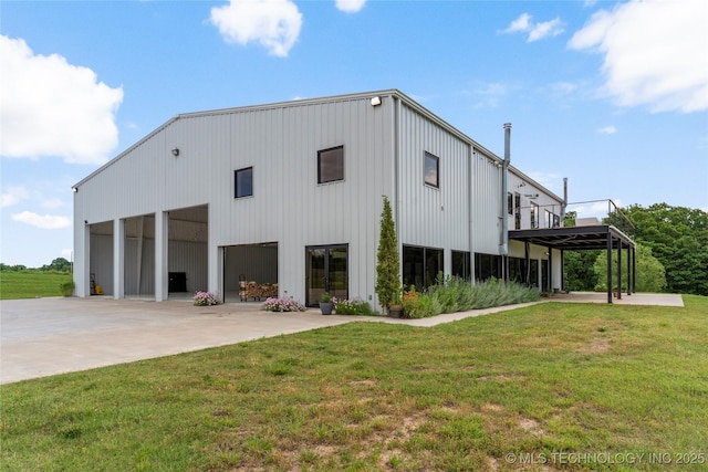 14382 Adams Rd, Mounds, OK 74047 - view of pole building with a lawn, a garage, and driveway