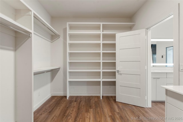 14382 Adams Rd, Mounds, OK 74047 - walk in closet featuring wood finished floors