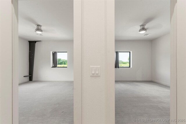 14382 Adams Rd, Mounds, OK 74047 - hallway with carpet flooring and healthy amount of natural light